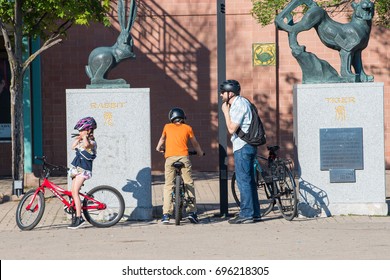 Chicago, IL, August 12, 2017: A Family Prepares To Ride Their Bikes Home After Visiting Chinatown, A Very Popular And Family Friendly Neighborhood In Chicago Which Attracts Many Visitors Daily.