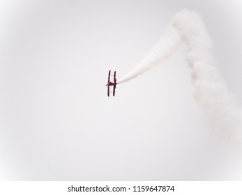 Chicago, IL - August 18th, 2018: Legendary Sean Tucker performs aerobatic stunts leaving trails of smoke over the city and entertaining the crowds watching from below at the annual Air and Water show.