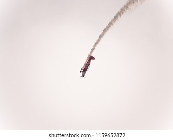 Chicago, IL - August 18th, 2018: A member of Team Oracle performs aerobatic stunts leaving trails of smoke over the city and entertaining the crowds below at the annual Air and Water show.