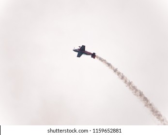 Chicago, IL - August 18th, 2018: A member of Team Oracle performs aerobatic stunts leaving trails of smoke over the city and entertaining the crowds below at the annual Air and Water show.