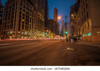 Chicago, IL December 10, 2020, Trees Lit Up In Christmas Holiday Lights Along Michigan Avenue In The Evening With Car Light Trails On The Road At Night