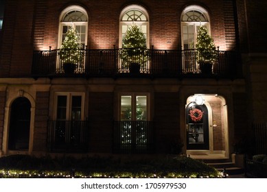 Chicago, IL December 17, 2017, Front Of House Decorated With Multiple Christmas Trees Lit Up At Night On Second Floor Balcony