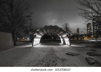 Chicago, IL - January 23, 2018: The People's Gas Pavilion Designed By Architect Jeanne Gang Arches Over The Building Skyline On A Still Winter Night In Chicago.