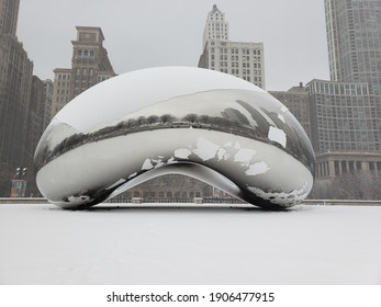 Chicago, IL January 26, 2021, The Bean, Cloud Gate In Millennium Park With Skyscrapers In The Background Covered In Snow During A Winter Snowstorm