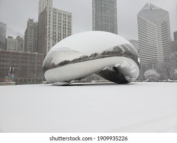 Chicago, IL January 26, 2021, The Bean, Cloud Gate In Millennium Park With Skyscrapers In The Background Covered In Snow During A Winter Snowstorm