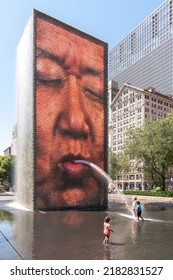 Chicago, IL - July 12th, 2022: Children Play And Splash In The Water Fountain And Reflecting Pool In A Public Park Downtown As Water Shoots Out Of The Towers On A Hot Summer Day.