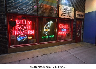 Chicago, IL - July 15, 2017: Famous scene downtown Chicago. The iconic Billy Goat Tavern sign welcomes into the dark Lower Wacker underpass beneath the upscale Michigan Avenue shopping district.