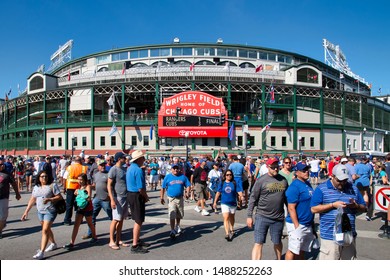 Chicago, IL - July 16, 2016: Fans stream across the intersection of Clark and Addison streets at Wrigley Field after a Chicago Cubs baseball during a beautiful summer day.                     