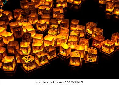 Chicago, IL - July 20th, 2019:  Glowing orange lanterns float across the South Lagoon at the Water Lantern Festival in Lincoln Park Saturday evening with music, food and family friendly activities.