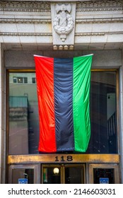 Chicago, IL, June 19th, 2021, Red, Black And Green, The African Liberation Flag Draped Hanging From The Side Of A Building For Juneteenth