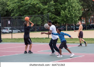 CHICAGO, IL, June 21, 2017: As Father's Day Approaches, A Young Father And His Son Play Basketball In Wicker Park, A Neighborhood That Offers Many Family Friendly Activities.