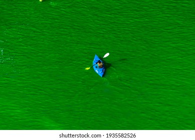 Chicago, IL - March 13th, 2021: A Kayak Paddles Down The Freshly Dyed Chicago River As The City Turned The Water Green In A Surprise St. Patrick's Holiday Event Restarting The Annual Tradition.