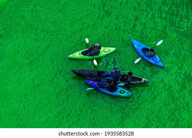 Chicago, IL - March 13th, 2021: Kayak Boats Paddle Down The Freshly Dyed Chicago River As The City Turned The Water Green In A Surprise St. Patrick's Holiday Event Restarting The Annual Tradition.