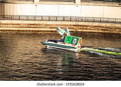 Chicago, IL - March 13th, 2021: Members Of The Chicago Local 130 Plumber's Union Make Their Initial Pass Dumping Dye Into The Chicago River Turning It Green In A Surprise St. Patrick's Day Event.