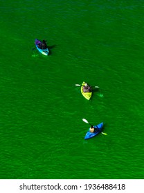 Chicago, IL - March 13th, 2021: Kayak Boats Paddle Down The Freshly Dyed Chicago River As The City Turned The Water Green In A Surprise St. Patrick's Holiday Event Restarting The Annual Tradition.