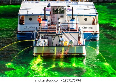 Chicago, IL - March 13th, 2021:  Plumbers Local 130 UA Aboard The Shoreline Sightseeing's Cityview Boat Shoot Water Jets And Dye The River Green For St. Patrick's Day In A Surprise Holiday Event.