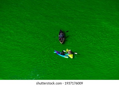 Chicago, IL - March 13th, 2021: Kayak Boats Paddle Down The Freshly Dyed Chicago River As The City Turned The Water Green In A Surprise St. Patrick's Holiday Event Restarting The Annual Tradition.