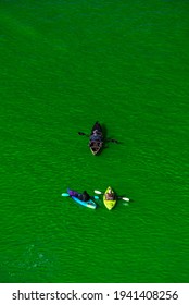 Chicago, IL - March 13th, 2021: Kayak Boats Paddle Down The Freshly Dyed Chicago River As The City Turned The Water Green In A Surprise St. Patrick's Holiday Event Restarting The Annual Tradition.