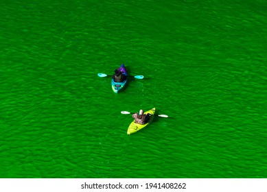 Chicago, IL - March 13th, 2021: Kayak Boats Paddle Down The Freshly Dyed Chicago River As The City Turned The Water Green In A Surprise St. Patrick's Holiday Event Restarting The Annual Tradition.