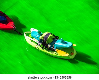 Chicago, IL - March 16th, 2019:  Kayak Boats Gather In The Freshly Dyed Chicago River On St. Patrick's Day As They Get An Up Close Look At The Bright Green Water.