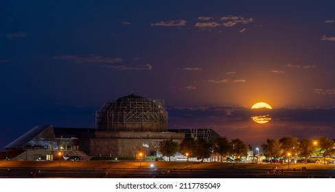 Chicago, IL - May 26 2021: Full moon rising behind Adler Planetarium in Chicago