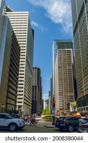 Chicago, IL - May 30, 2019: Narrow Street With Pedestrians And Cars Between Tall Skyscrapers In A Sunny Day