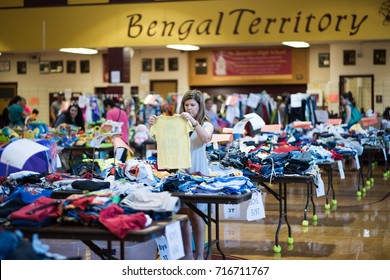 Chicago, IL, September 16, 2017: People Look Through Objects For Sale At A Community Yard Sale  For Young Families In A Church Gym In The North Center Neighborhood, Known For Being Family Friendly.