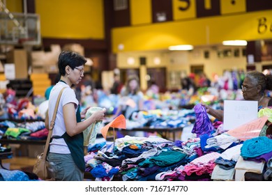 Chicago, IL, September 16, 2017: People Look Through Objects For Sale At A Community Yard Sale  For Young Families In A Church Gym In The North Center Neighborhood, Known For Being Family Friendly.