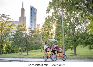 Chicago, IL - September 19, 2022: People Ride A Pedicab Along The Lakefront Trail, By Lake Michigan, With Parks And The City Skyline In The Distance.