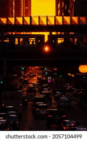 Chicago, IL - September 23rd, 2021: Light Shines Through Between Train Cars During The Fall Henge Where The Sun Aligns With The City's Street Grid Creating Long Shadows And Orange Light In The Street.