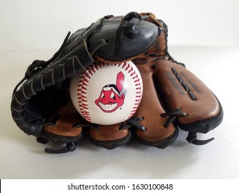 Chicago, IL September 9, 2019, Close up  view of a white baseball ball Chief Wahoo Cleveland Indians mascot logo inside tan baseball glove on a white neutral background, major league baseball, Louisvi