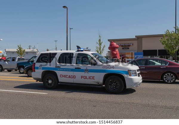 Chicago, IL U.S. - 6/4/2018: A\
Chicago Police Department Chevy Tahoe travels down West 79th Street\
in a funeral procession for a fallen Chicago Firefighter on\
6/4/2018.