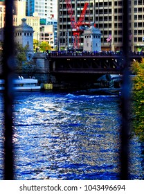 Chicago, IL / USA - 11/4/2016: Cubs Win! Chicago River Dyed Blue During 2016 Celebration Of The Cubs Winning The World Series Of Baseball. Seen Through Fence Railing. 