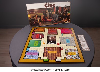 Chicago, IL / USA - April 5, 2020: View Of The Whole Board Of A Vintage, Antique Clue Game With The Box Behind. Illustrative Editorial.