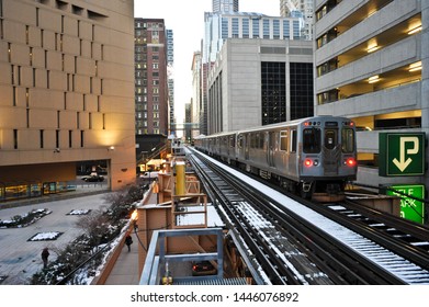 CHICAGO, IL , USA - DECEMBER 8 2010: A Northbound CTA Brown Line Train Leaving Library-State Van Buren Station Travels Past The City Jail Building Inside The Loop.