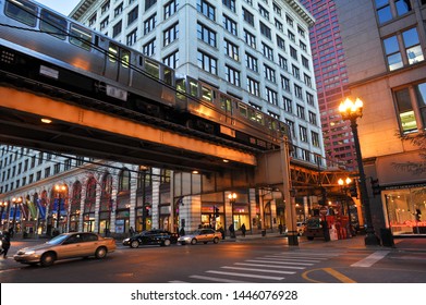 CHICAGO, IL / USA - DECEMBER 8 2010: A Brown Line Train Rides On The Elevated Tracks Over E Van Buren At S State Street, Past DePaul University DePaul Center And The Robert Morris Center.