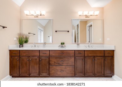 CHICAGO, IL, USA - FEBRUARY 25, 2020: A Modern Master Bathroom With A Dark Wood Vanity And Light Colored Counter Top.