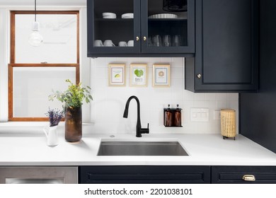 CHICAGO, IL, USA - JULY 13, 2022: A Kitchen Detail Shot With Blue Cabinets, A White Marble Countertop, And Cozy Decor.