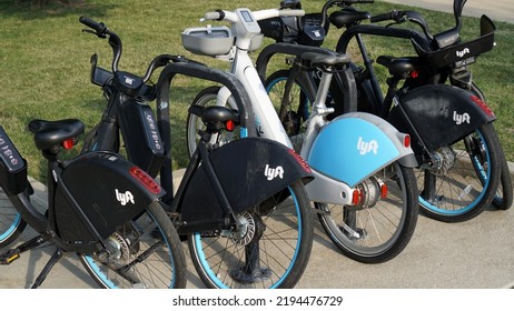 Chicago, IL, USA - July 21 2022: Lyft Divvy Ride Share Bikes Parked On A Bike Rack At A Chicago Park.                                