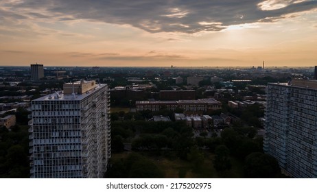 Chicago, IL USA July 4th 2022: Aerial drone footage of a Chicago neighborhood downtown. the city beautiful architectural is also covered by lush green trees throughout while the sunset is gold