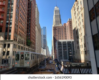 Chicago, IL / USA - June 18 2019: Downtown Chicago On The El (elevated) Train Tracks At Washington & Wells With Randolph Tower City Apartments In The Background And Orange Line CTA