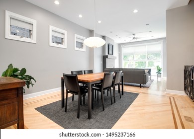 CHICAGO, IL, USA - JUNE 25, 2019: A Luxurious Dining Room Area That Connects To The Living Room. This Spacious Area Can Fit A Large Table With A Modern Light Hanging Down Over The Top.