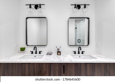 CHICAGO, IL, USA - JUNE 7, 2020: A Beautiful Modern Bathroom With A Wood Vanity, White Marble Counter Top, And A Custom Tiled Stand Up Shower.