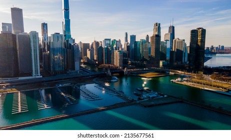 Chicago, IL USA- March 13th 2022: Aerial Drone Shot Of Downtown Chicago By The River During Early Spring Summer.  The Beautiful Skyscrapers Look Futuristic  Along The Green Lake Water