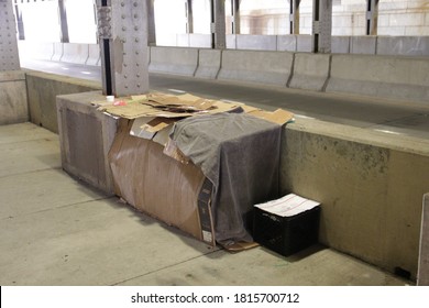 Chicago, IL / USA - May 6, 2020: A Selfmade Homeless Shelter, Made From Old Cardboard Boxes, Located Under A Busy City Transit Overpass.