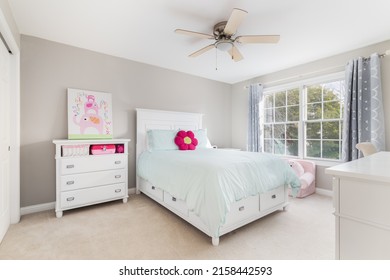 CHICAGO, IL, USA - NOVEMBER 1, 2020: A Girls Bedroom With White Furniture And A Bed With A Light Blue Bedding And A Flower Pillow.