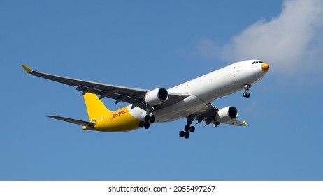 Chicago, IL, USA - October 9 2021: DHL Airbus A330 cargo plane prepares for landing at Chicago O'Hare International Airport.