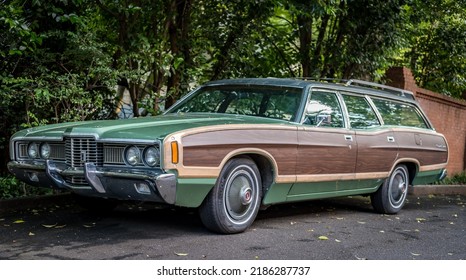 Chicago, Illinois - 17 May 2017: Classic American Station Wagon From The 1970s. Wood Inlay On The Side, Parked In Front Of Trees And A Brick Wall