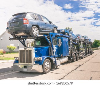 CHICAGO, ILLINOIS -  August 15: A auto carrier truck with cars loaded for transport on August 15th 2013. Moving industry has turnover of over US $12 Billion