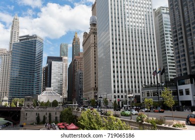 CHICAGO, ILLINOIS - AUGUST 17, 2017: A Bright And Beautiful Day In Central Chicago Showing The Density Of The Business District Alongside The Green Chicago River.